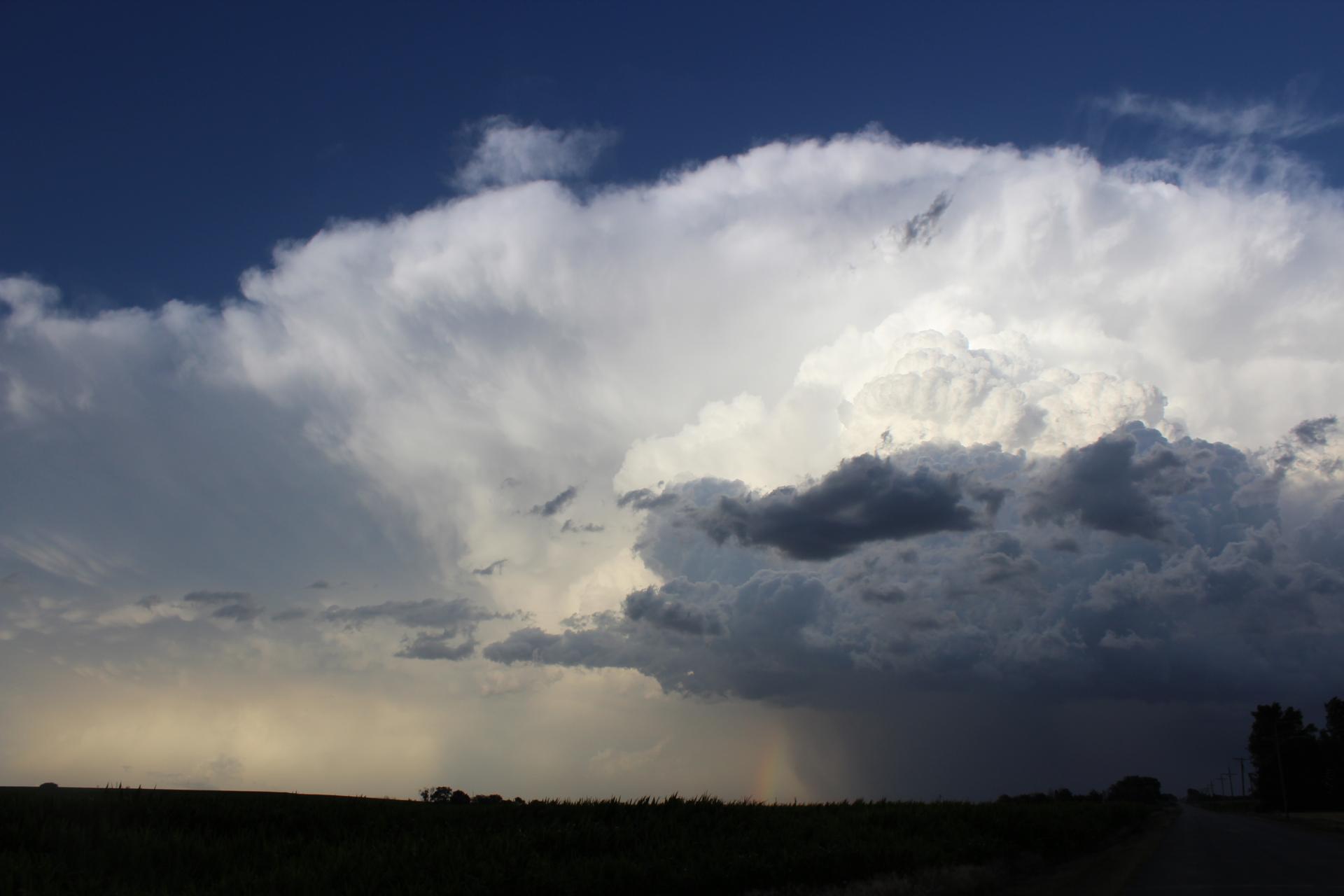 Image of a supercell thunderstorm towering over a road